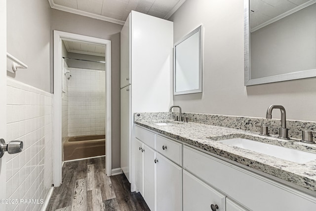 bathroom with crown molding, wood-type flooring, and vanity