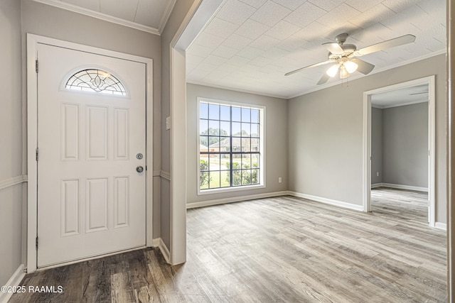 foyer entrance featuring ceiling fan, ornamental molding, and wood-type flooring