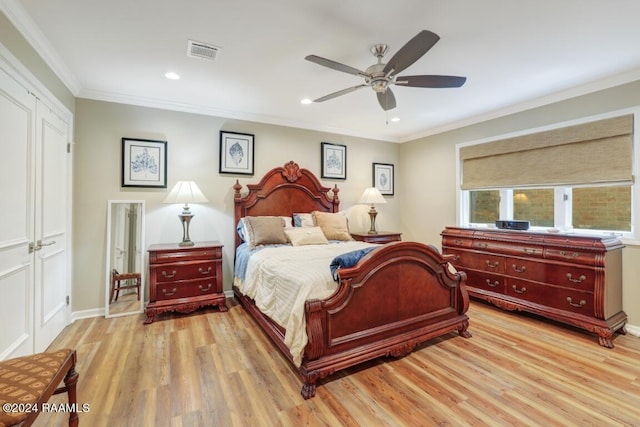 bedroom with light wood-type flooring, a closet, ceiling fan, and ornamental molding