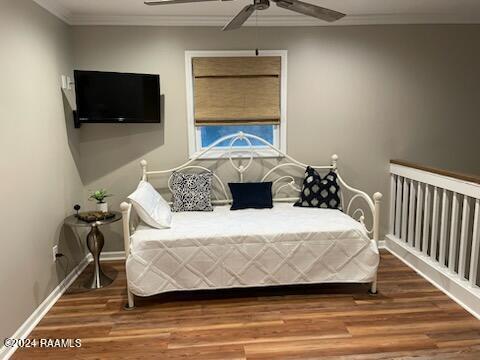 bedroom featuring hardwood / wood-style floors, ceiling fan, and crown molding