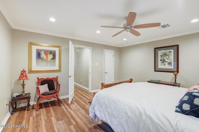 bedroom with ceiling fan, light wood-type flooring, and crown molding