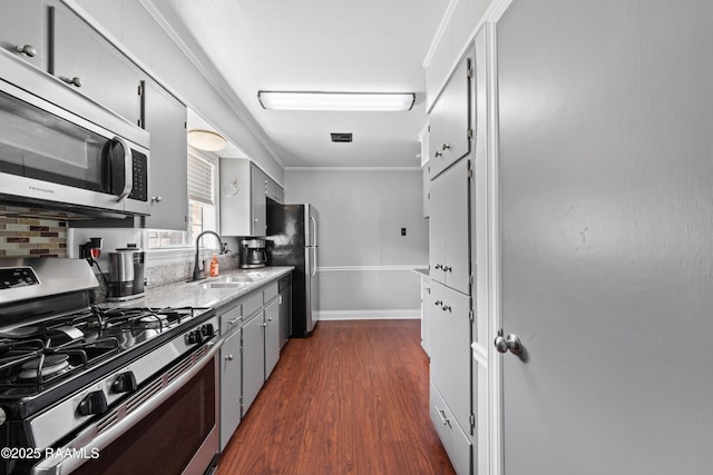 kitchen featuring sink, stainless steel appliances, crown molding, and dark hardwood / wood-style floors