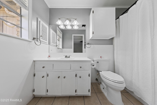 bathroom with toilet, vanity, tile patterned floors, and ornamental molding