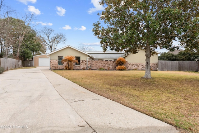 ranch-style home with an outbuilding, a garage, and a front yard