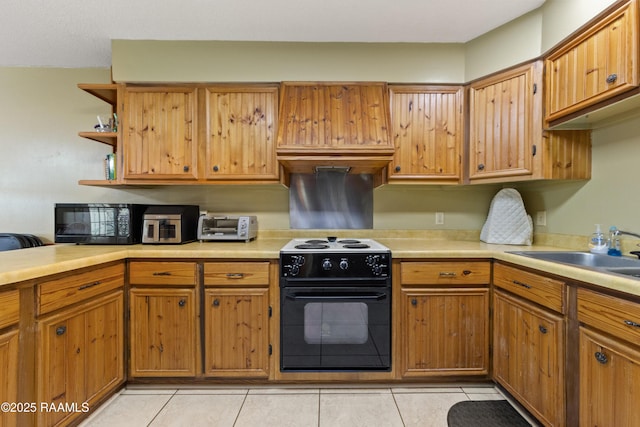 kitchen with sink, range with electric cooktop, and light tile patterned floors