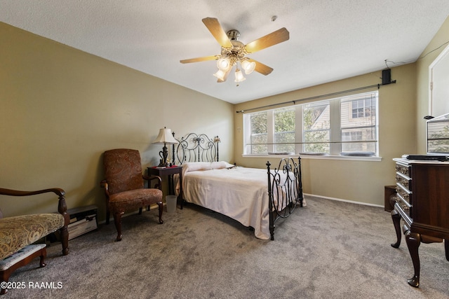 bedroom featuring light carpet, ceiling fan, and a textured ceiling