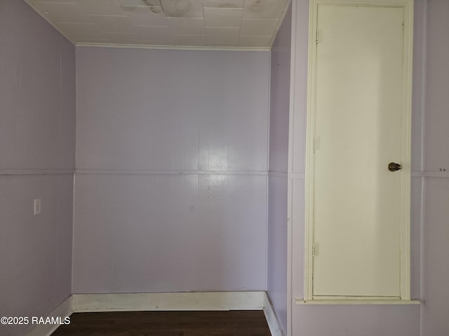 unfurnished room featuring ornamental molding and wood finished floors