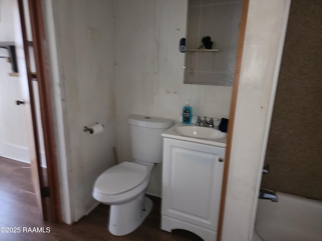 bathroom featuring wood finished floors, vanity, and toilet