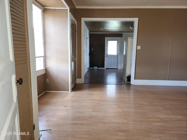 foyer entrance featuring baseboards and light wood-style floors