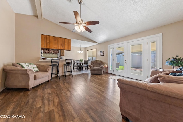 living room featuring dark hardwood / wood-style flooring, vaulted ceiling with beams, a textured ceiling, and ceiling fan