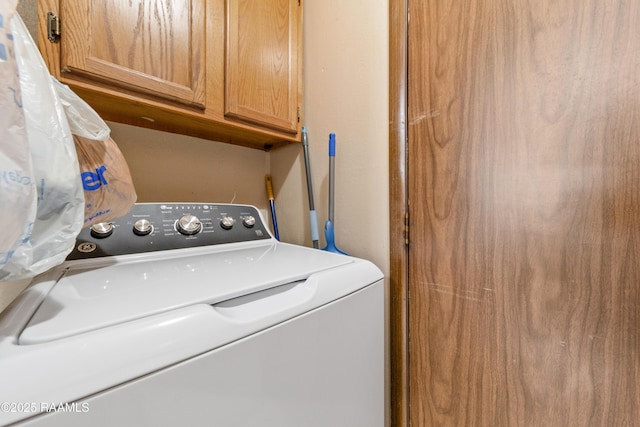 laundry room featuring washer / clothes dryer and cabinets