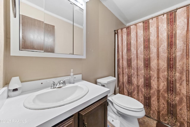 bathroom with vanity, toilet, and ornamental molding