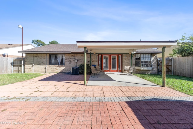 back of house with a yard, french doors, and a patio