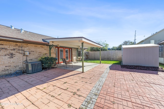 view of patio / terrace with a storage unit, central air condition unit, and french doors