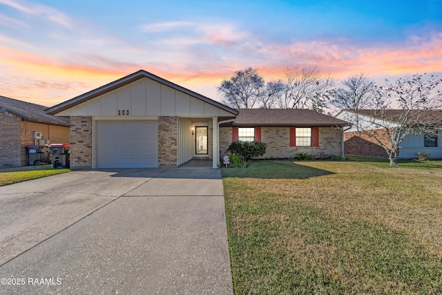 ranch-style house with a yard and a garage