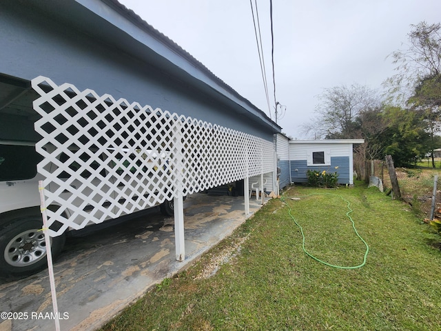 view of side of property with a yard and fence