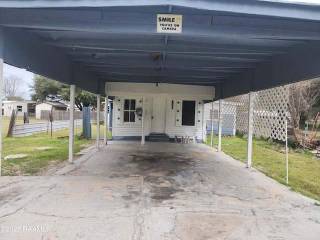 exterior space with entry steps, an attached carport, and fence