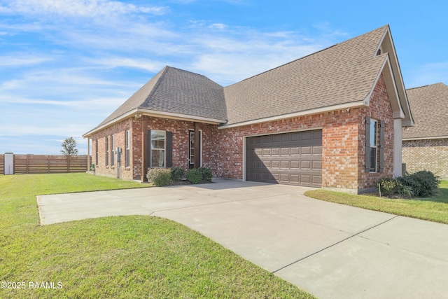 view of front of home featuring a garage and a front lawn