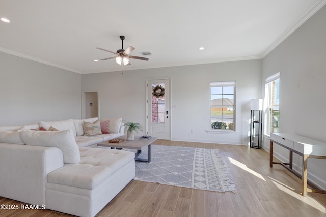 living room with ceiling fan, light hardwood / wood-style floors, and ornamental molding