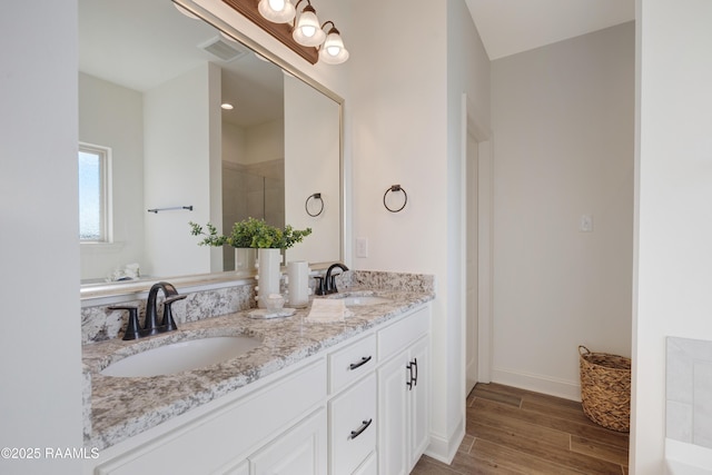 bathroom featuring vanity and an enclosed shower