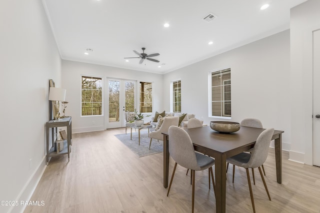 dining room with french doors, light wood-type flooring, ceiling fan, and ornamental molding