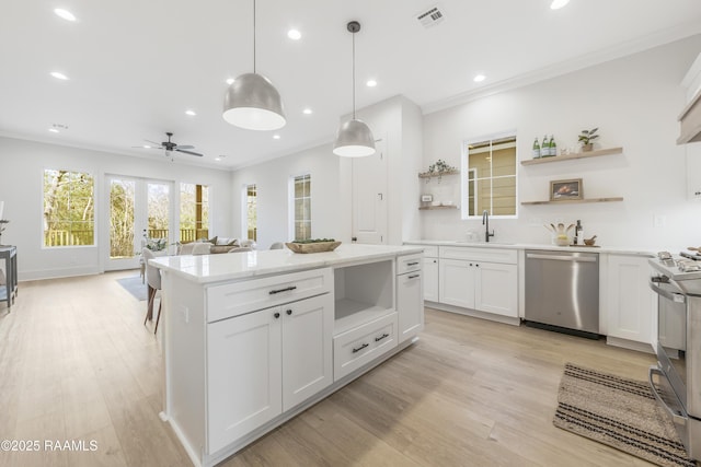 kitchen featuring white cabinetry, ceiling fan, hanging light fixtures, and appliances with stainless steel finishes