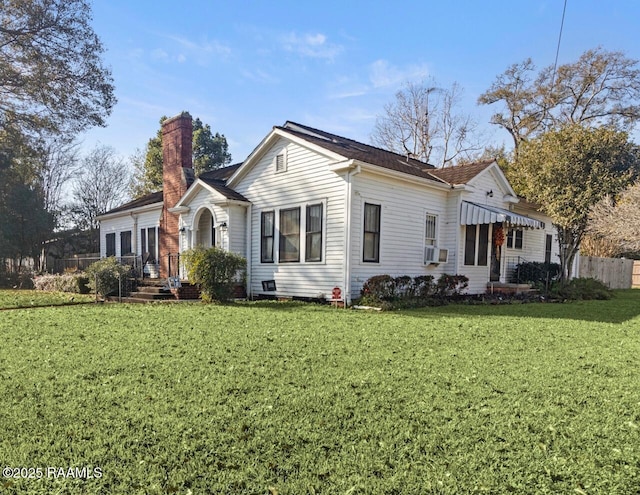 view of front of house with cooling unit and a front yard