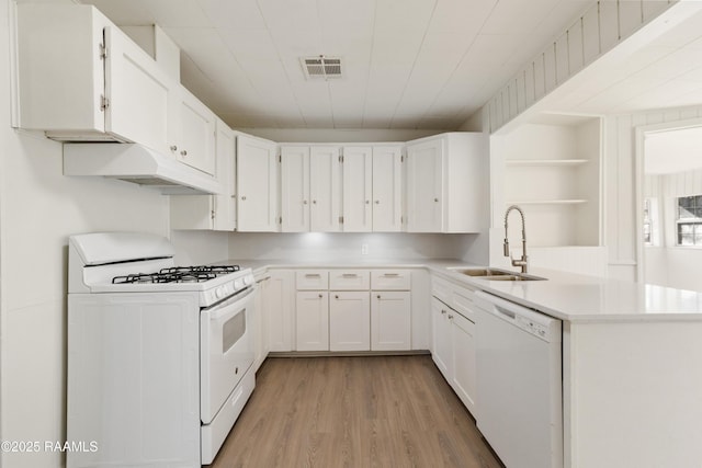 kitchen featuring built in shelves, white appliances, sink, light hardwood / wood-style floors, and white cabinetry