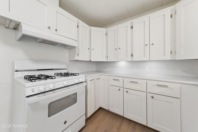 kitchen with white cabinets, white gas stove, and dark hardwood / wood-style flooring