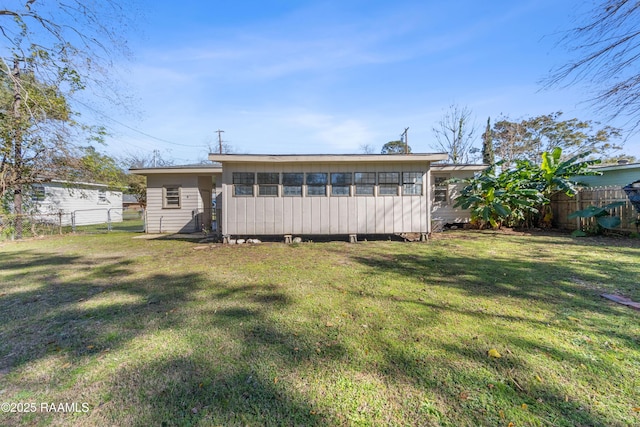 back of house with a yard