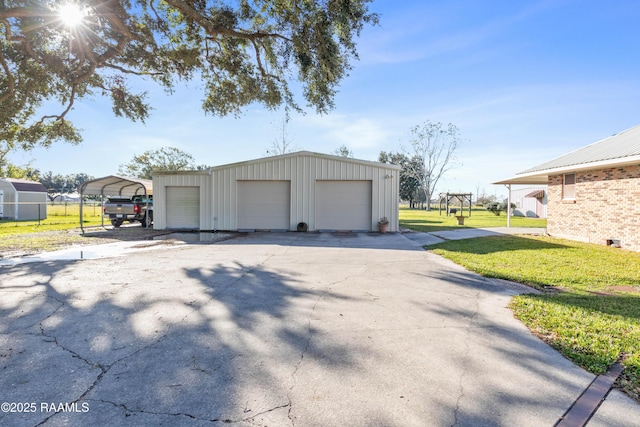 garage with a carport and a yard