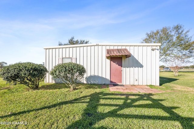 view of outbuilding featuring a lawn