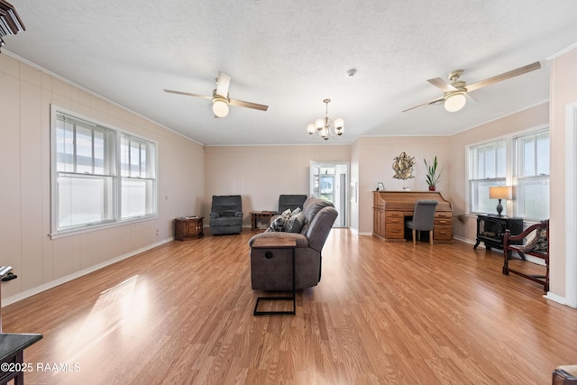 living room featuring crown molding, a wealth of natural light, and light wood-type flooring