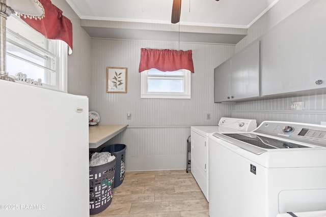 clothes washing area featuring separate washer and dryer, cabinets, ceiling fan, and light wood-type flooring