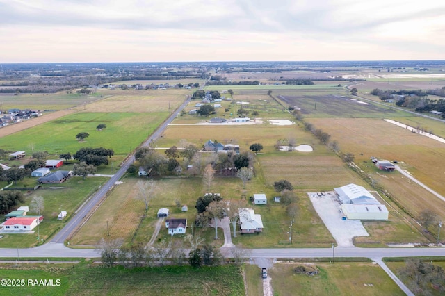 aerial view at dusk featuring a rural view