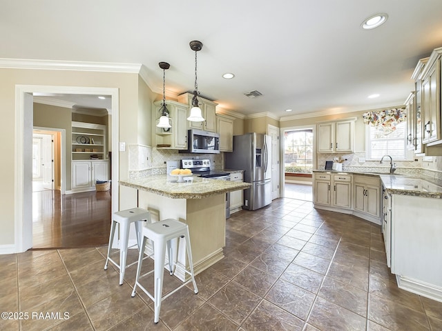 kitchen featuring a kitchen bar, light stone counters, hanging light fixtures, ornamental molding, and appliances with stainless steel finishes