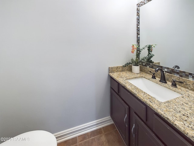 bathroom featuring vanity, toilet, and tile patterned flooring