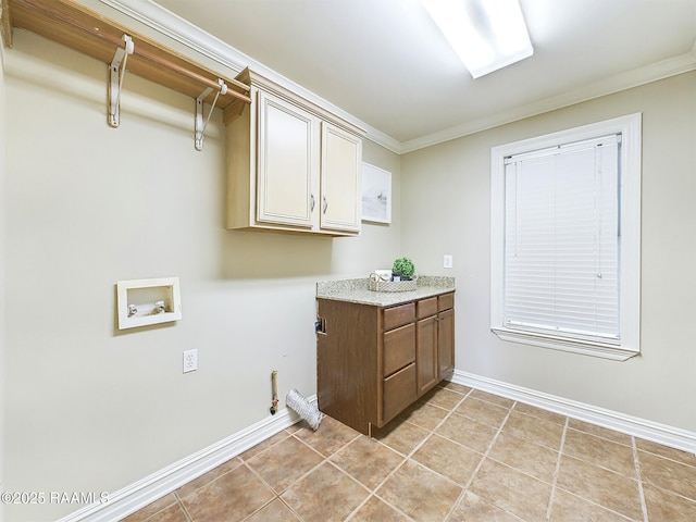 washroom with crown molding, cabinets, light tile patterned flooring, and hookup for a washing machine