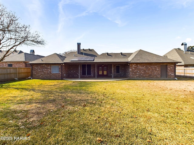 back of house with a patio and a yard