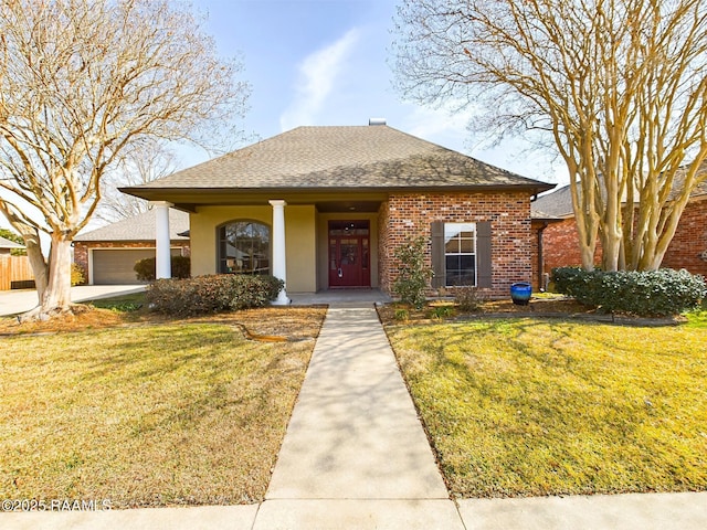 view of front of property with a garage and a front lawn