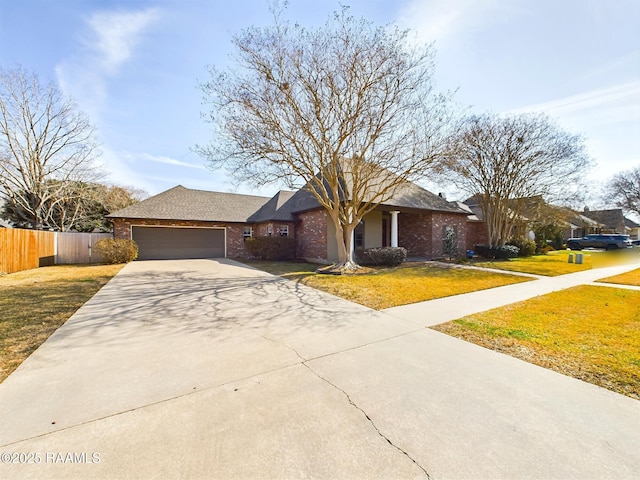 ranch-style house featuring a garage and a front lawn