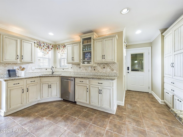 kitchen with sink, dishwasher, ornamental molding, decorative backsplash, and cream cabinetry