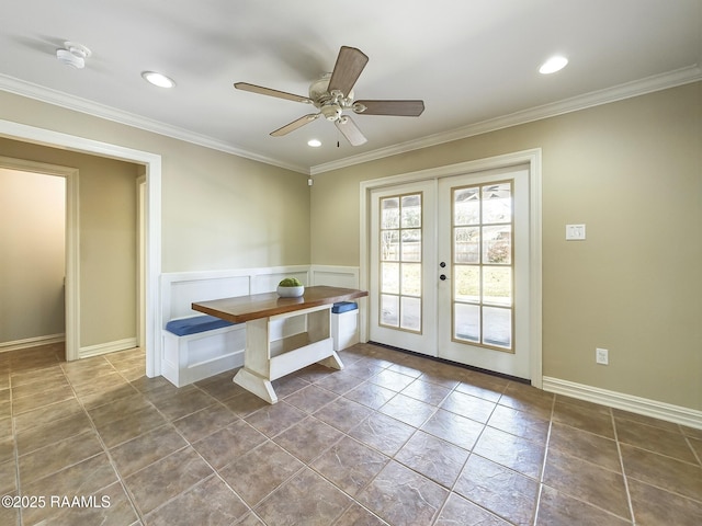 unfurnished dining area featuring ornamental molding, ceiling fan, and french doors