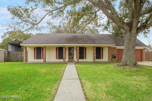 ranch-style house featuring a carport, a garage, covered porch, and a front yard