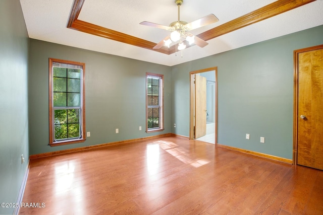 107 W Bayou Shr, Lafayette, LA 70508 - unfurnished bedroom featuring ceiling fan, a raised ceiling, light hardwood / wood-style flooring, ensuite bathroom, and ornamental molding