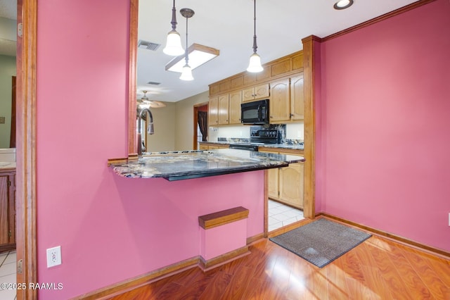 107 W Bayou Shr, Lafayette, LA 70508 - kitchen with ceiling fan, kitchen peninsula, light hardwood / wood-style floors, decorative light fixtures, and black appliances