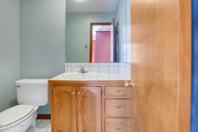 107 W Bayou Shr, Lafayette, LA 70508 - bathroom featuring tile patterned flooring, vanity, a textured ceiling, and toilet