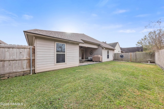 back of property with a patio and a yard