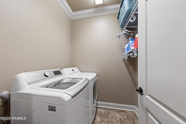 clothes washing area featuring washing machine and dryer and crown molding