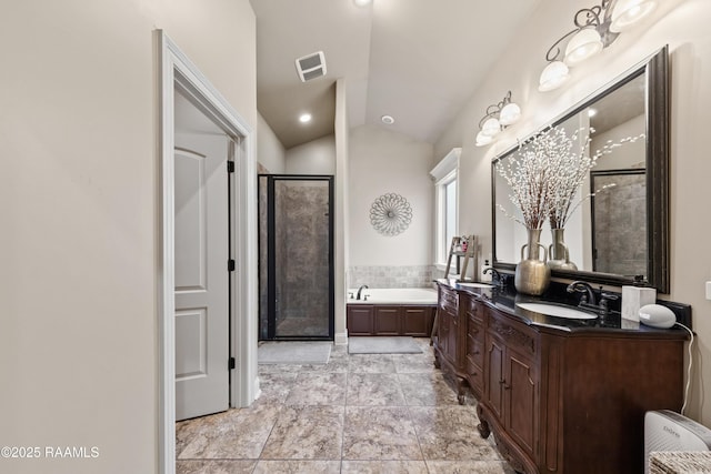 bathroom with shower with separate bathtub, vanity, and vaulted ceiling